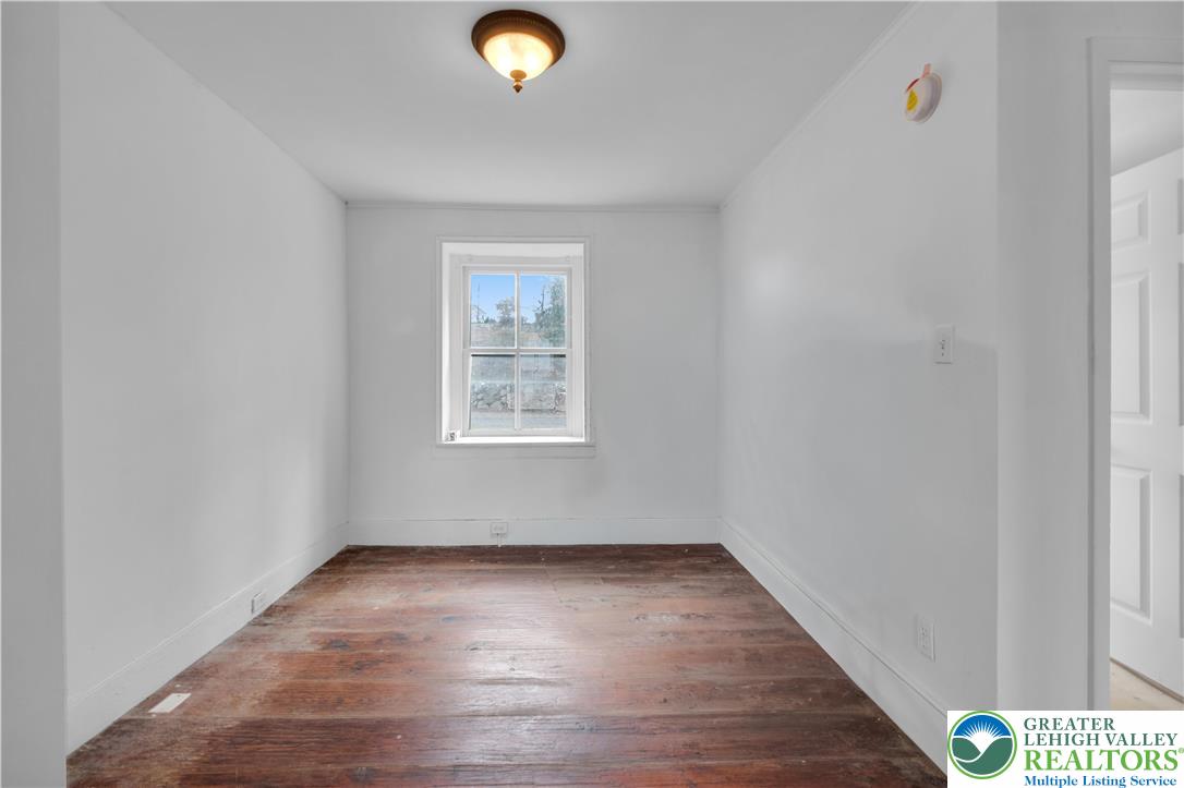 4828 Huckleberry Road Orefield, PA 18069 - Photo 23 of 41 an empty room with wooden floor and windows