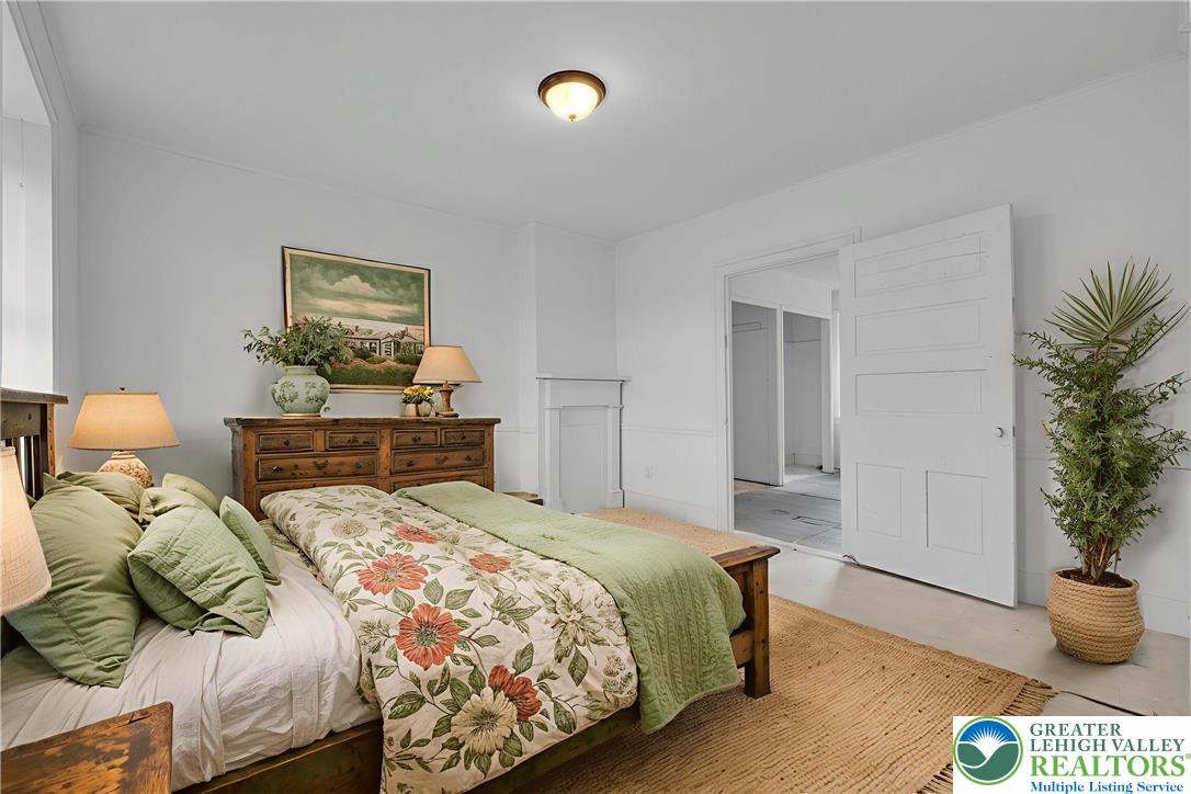 4828 Huckleberry Road Orefield, PA 18069 - Photo 32 of 41 a bedroom with a bed and a potted plant