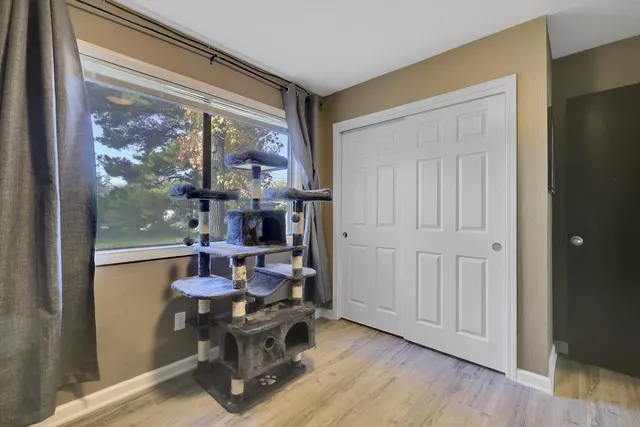 a room with wooden floor and a window