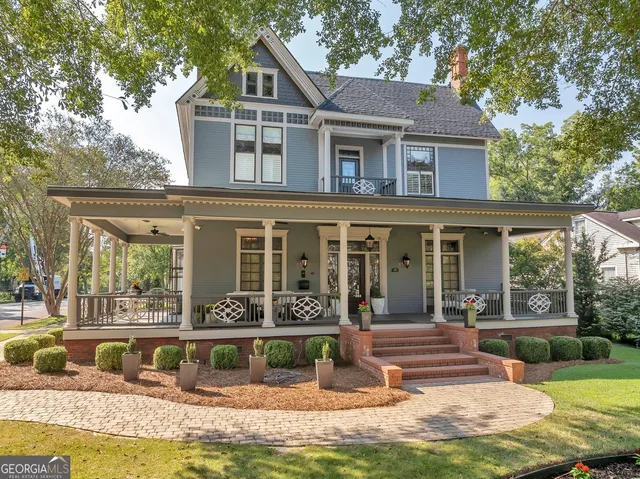 a front view of a house with a yard table and chairs