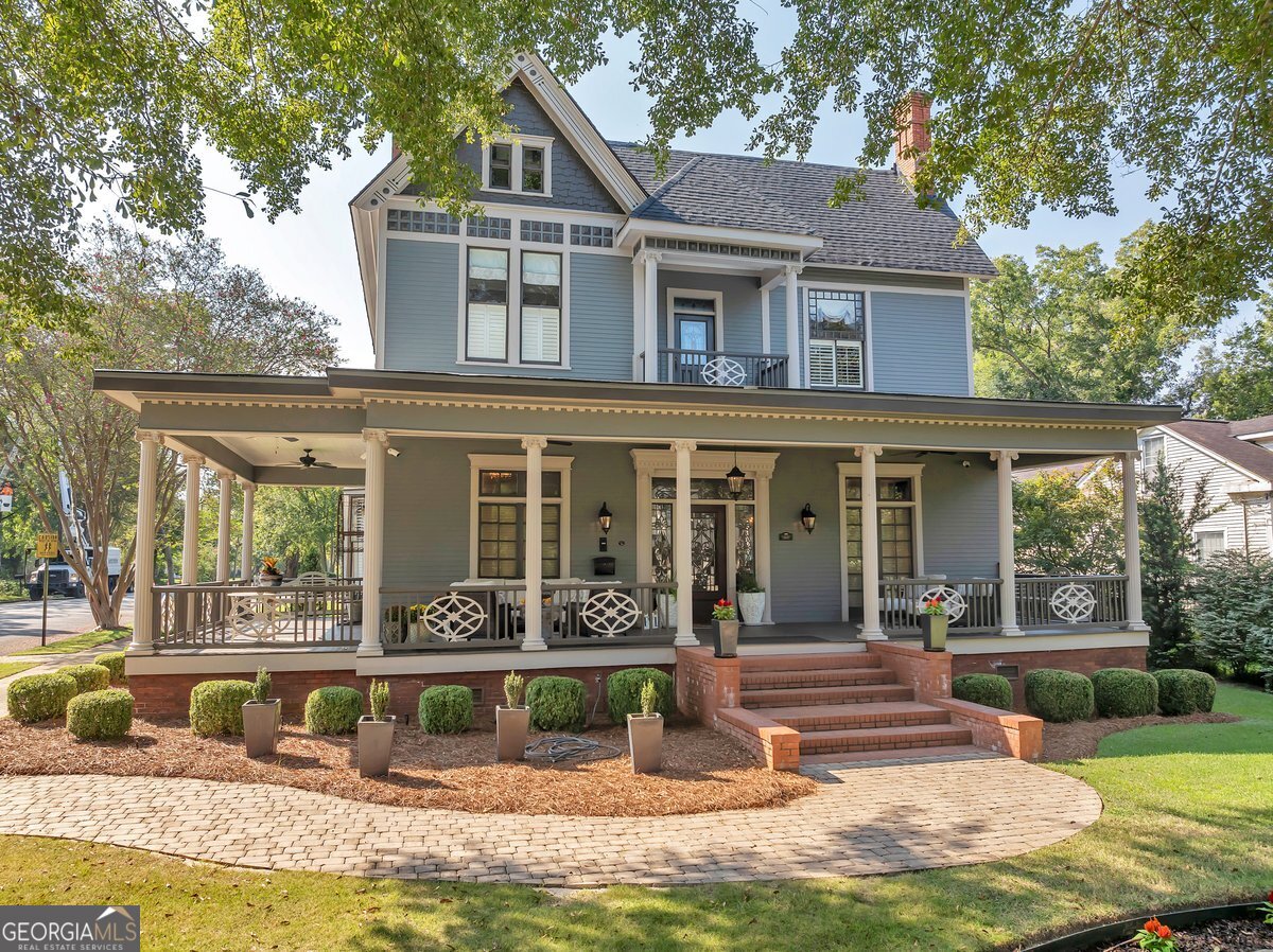 a front view of a house with a yard table and chairs
