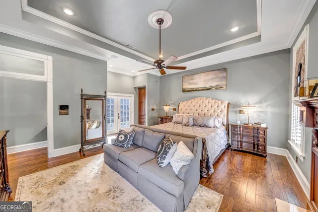 a view of a dining room and livingroom with furniture wooden floor a chandelier