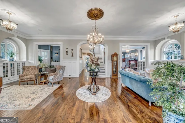 a living room with furniture and a chandelier