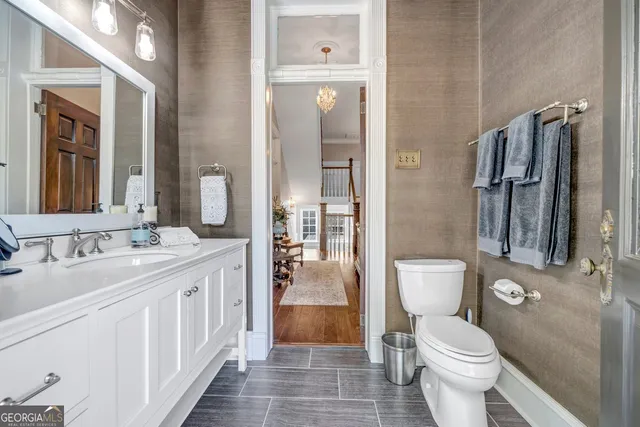 a view of a patio with couches table and chairs potted plants and large tree