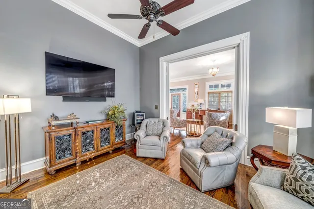 a living room with fireplace furniture and a chandelier
