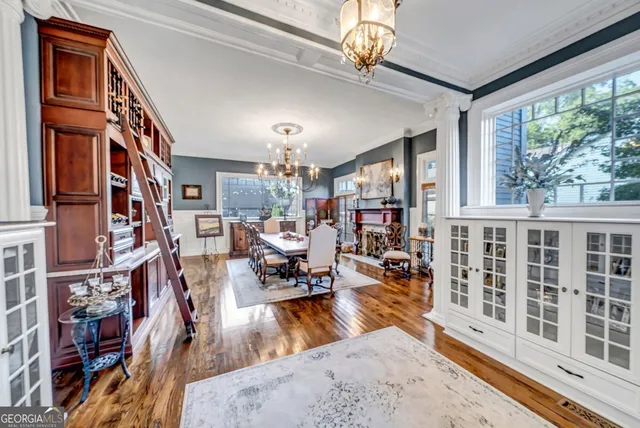a living room with a bed furniture and wooden floor