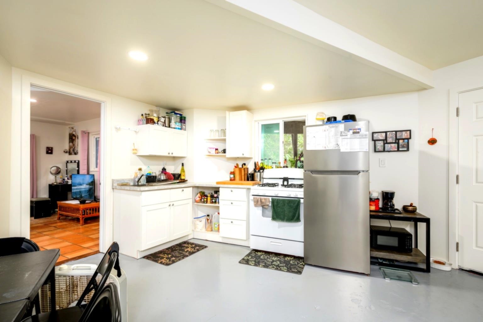 105 East Kuiaha Road Haiku, HI 96708 - Photo 21 of 24 a kitchen with a refrigerator a stove and a dining table