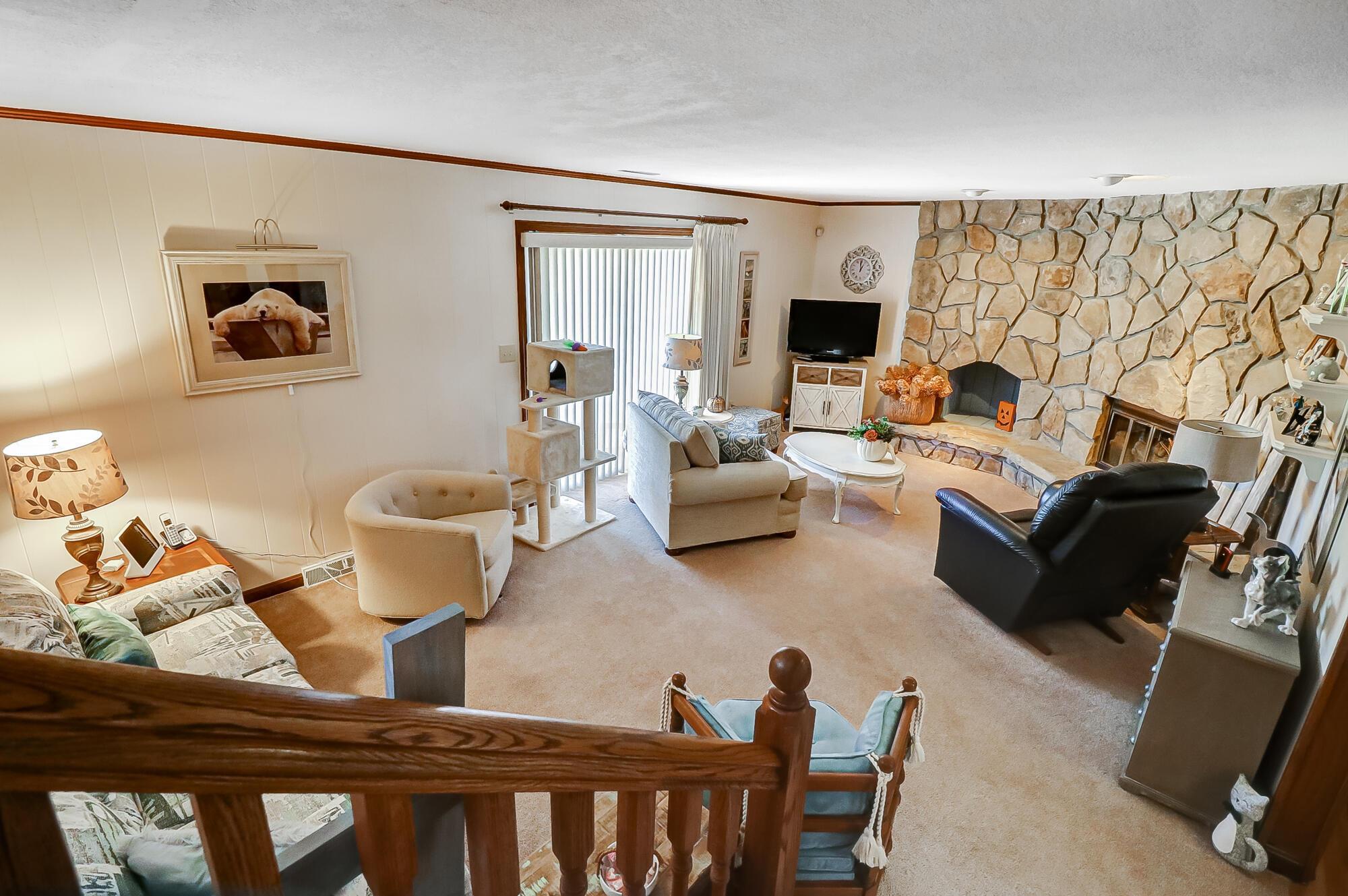 1000 Forest Hills Road Heath, OH 43056 - Photo 28 of 48 Large room with stone fireplace, sliding glass doors leading to patio