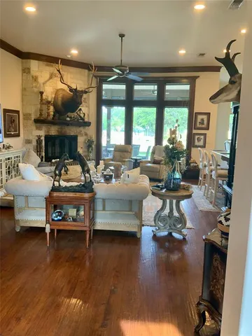 a living room with fireplace furniture and a large window