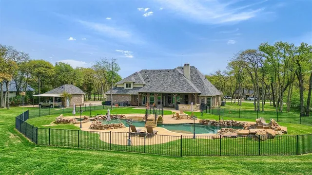 a view of a house with backyard sitting area and garden