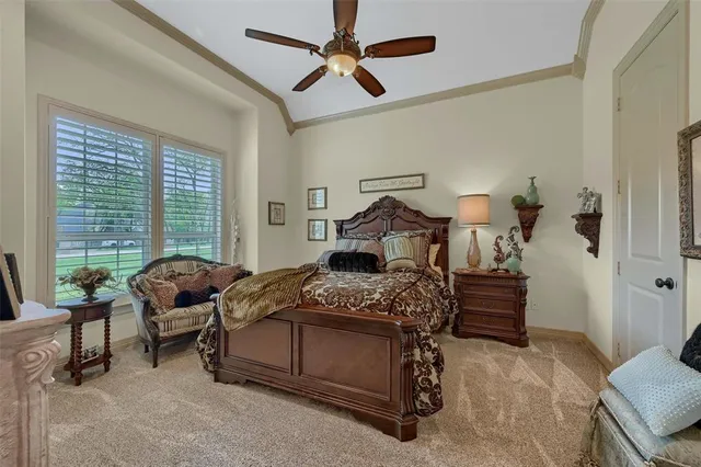 a bedroom with furniture and a large window