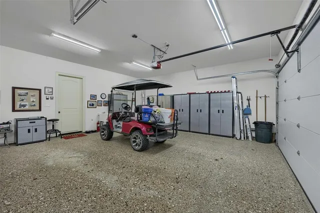 a open kitchen with stainless steel appliances granite countertop a sink dishwasher a stove a dining table and chairs with wooden floor