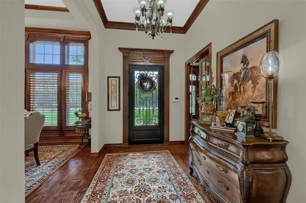 a living room with furniture kitchen view and a large window