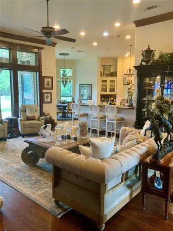 a living room with fireplace furniture and a large window