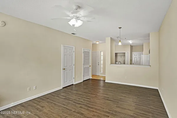 a view of an empty room with wooden floor