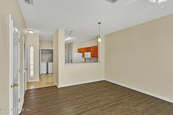a view of a room with wooden floor and window