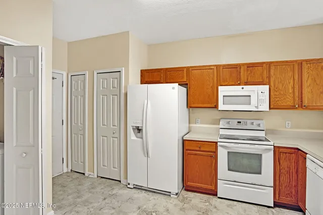 a kitchen with a stove and a refrigerator