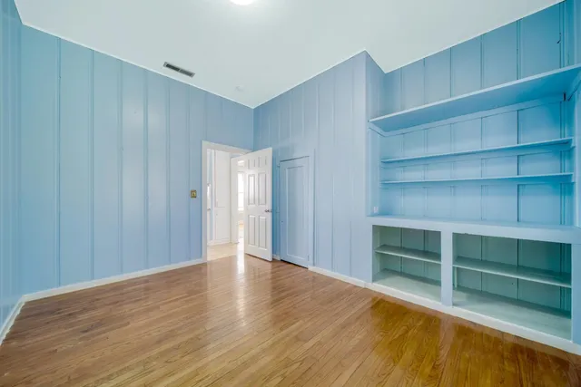 a view of an empty room with empty shelves