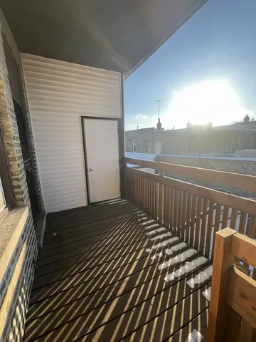 a view of a roof deck with wooden floor and fence