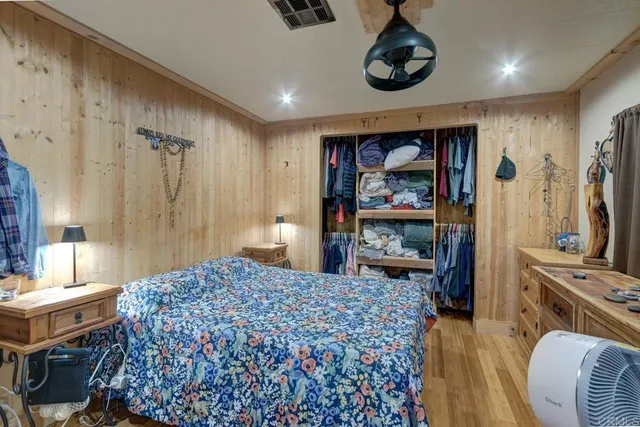 a bedroom with a bed and a dresser