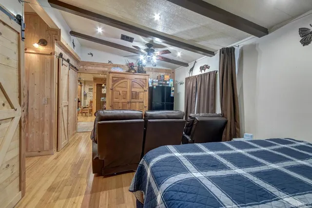 a bedroom with a bed next to a window with the outer view