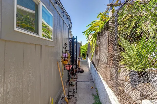 a view of walk in closet with clothes