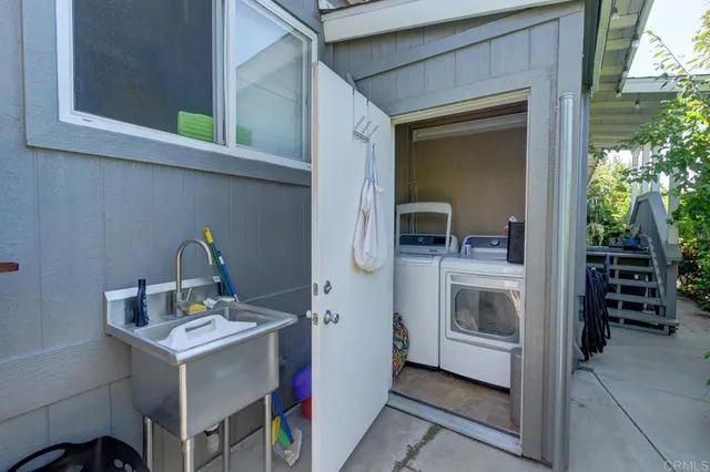 a utility room with sink dryer and washer