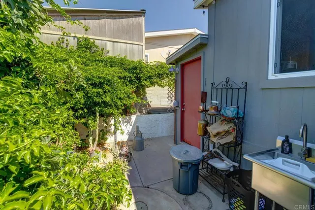a view of a house with backyard sitting area and garden