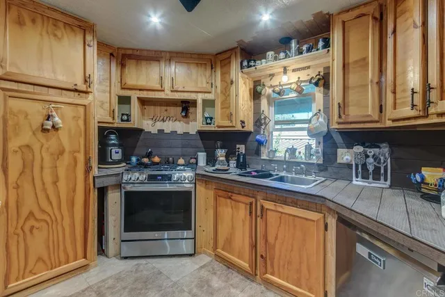 a kitchen with stainless steel appliances granite countertop a stove and a refrigerator