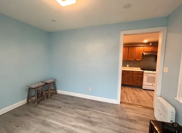 a view of a room with wooden floor and a sink