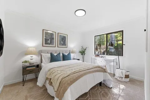a bedroom with bed and a window