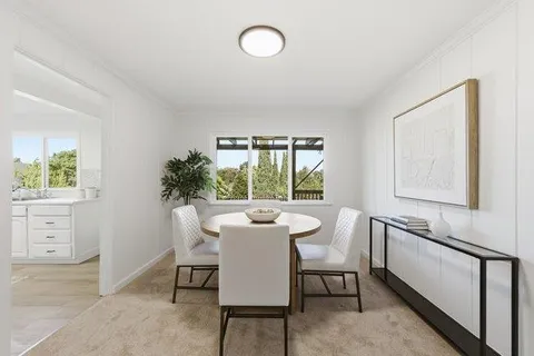 a dining room with furniture and window