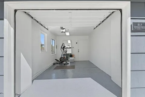 a view of a hallway with a white walls and stairs