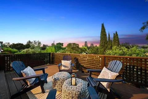 a view of a chairs and table in the roof deck