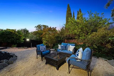 a view of a yard with furniture and a fire pit