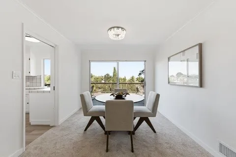 a dining room with furniture and a window