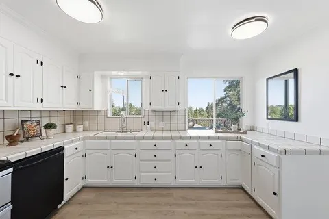 a kitchen with a sink cabinets and window