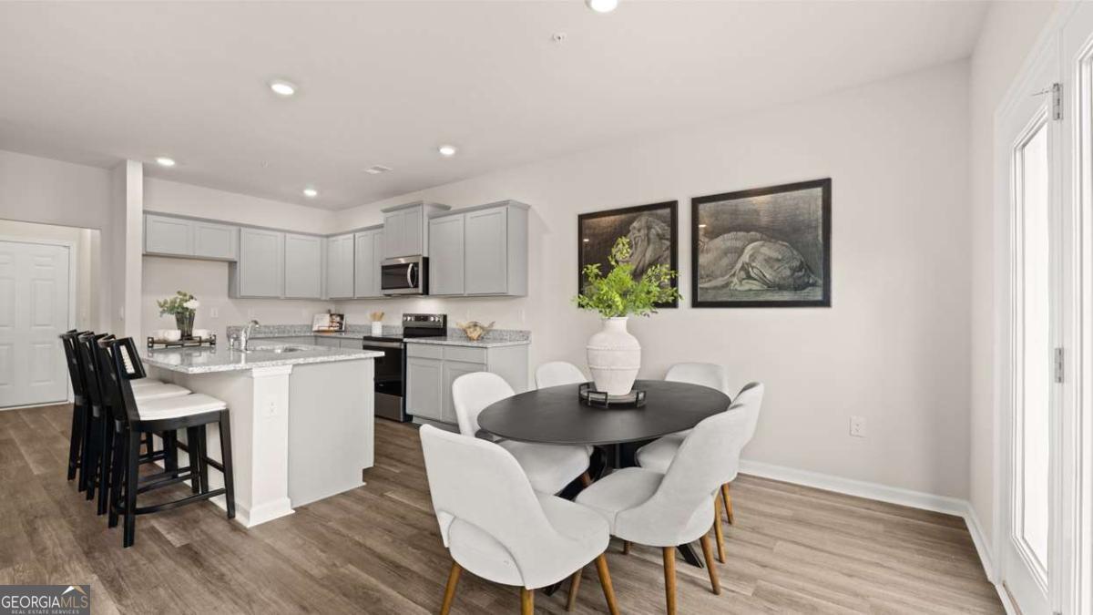 289 Sound Circle Stockbridge, GA 30281 - Photo 30 of 67 a kitchen with a dining table chairs and refrigerator
