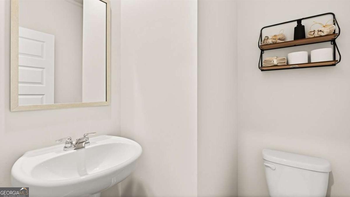 289 Sound Circle Stockbridge, GA 30281 - Photo 38 of 67 a bathroom with a sink a mirror and a toilet