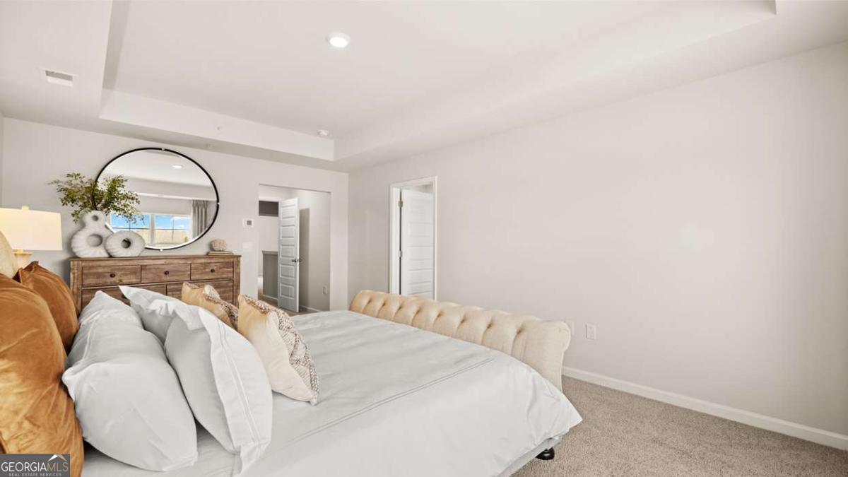 289 Sound Circle Stockbridge, GA 30281 - Photo 41 of 67 a bedroom with a bed and a chandelier