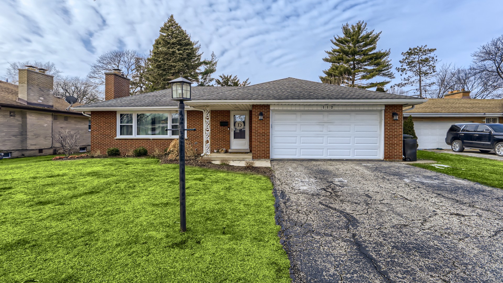 112 South Mt Prospect Road Mount Prospect, IL 60056 - Photo 1 of 27 a front view of a house with a yard and garage