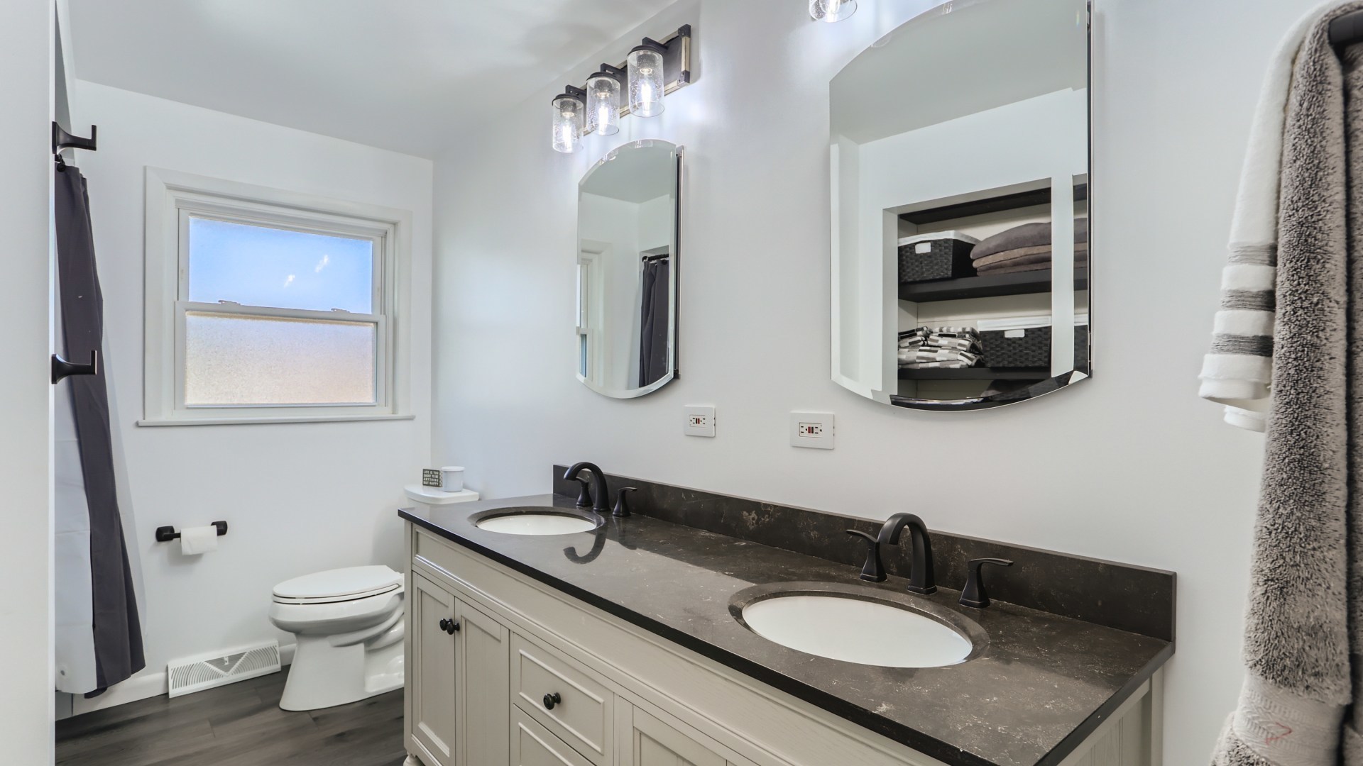 112 South Mt Prospect Road Mount Prospect, IL 60056 - Photo 15 of 27 a bathroom with a granite countertop toilet a sink and a mirror