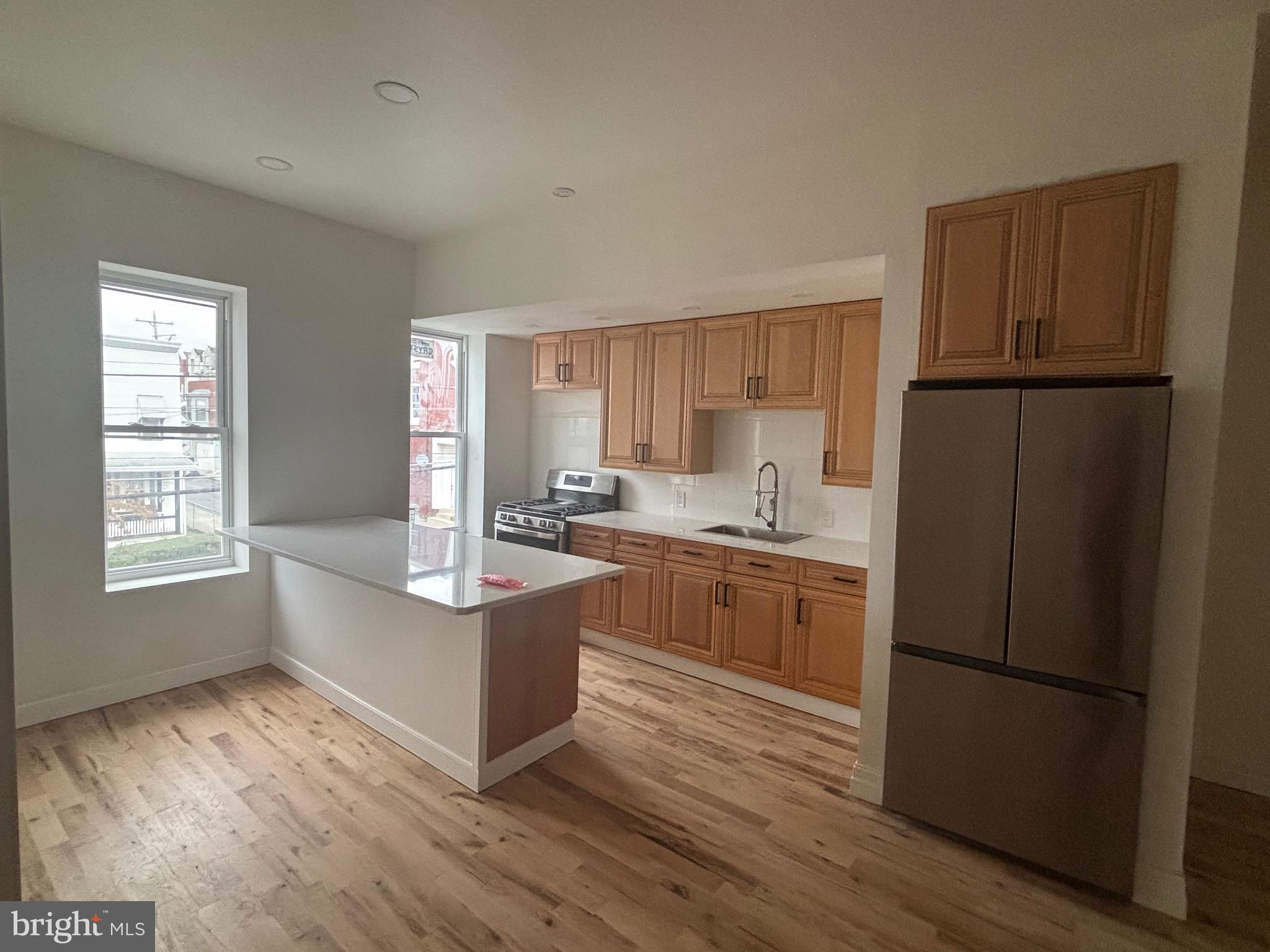 1120 Elm Street, Unit 2F Reading, PA 19604 - Photo 4 of 15 a kitchen with stainless steel appliances granite countertop a refrigerator a sink dishwasher a stove and a refrigerator
