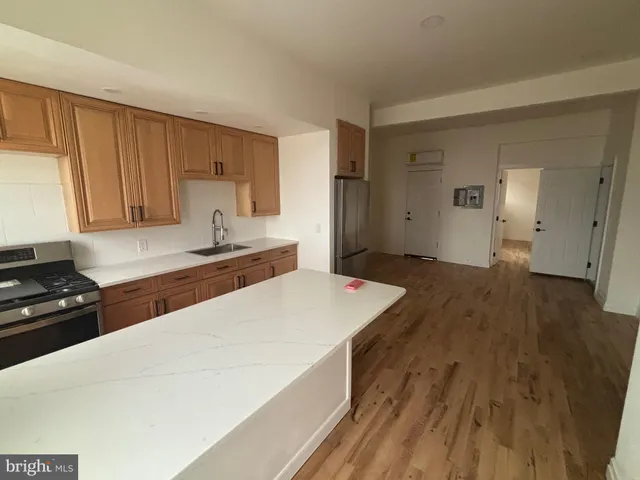 a kitchen with a wooden floor and cabinets