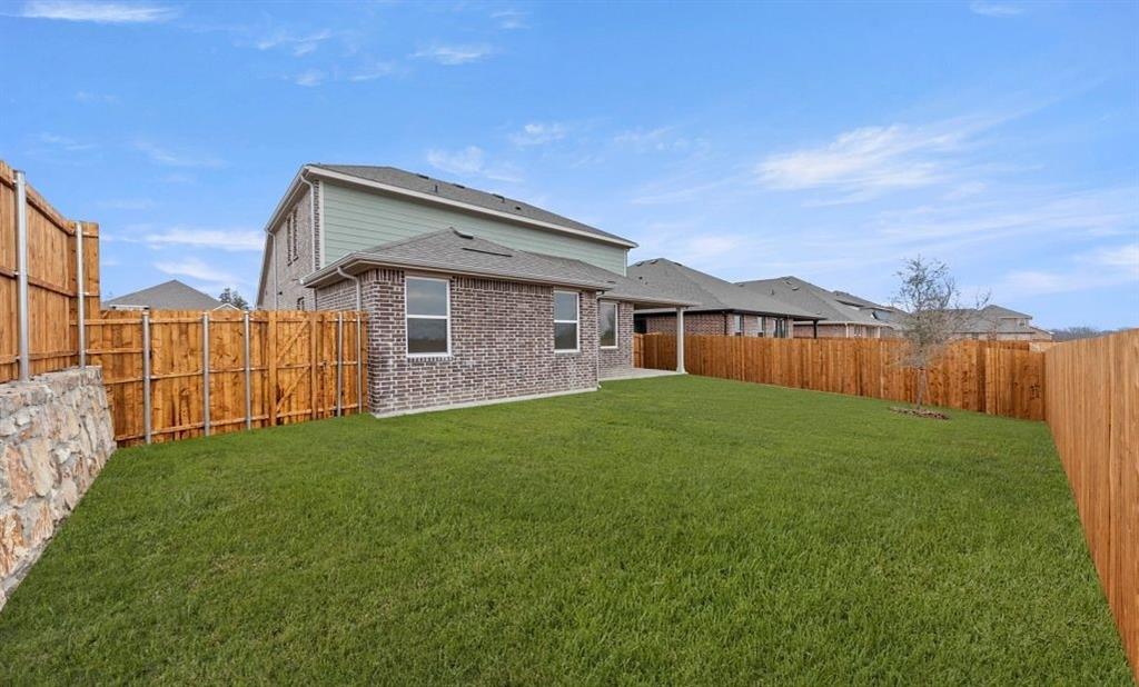 1005 Colgate Circle Princeton, TX 75407 - Photo 12 of 40 a view of a backyard with a garden