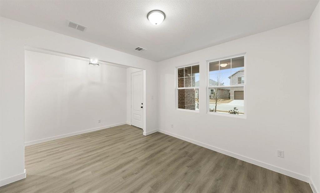 1005 Colgate Circle Princeton, TX 75407 - Photo 16 of 40 a view of an empty room with wooden floor and a window