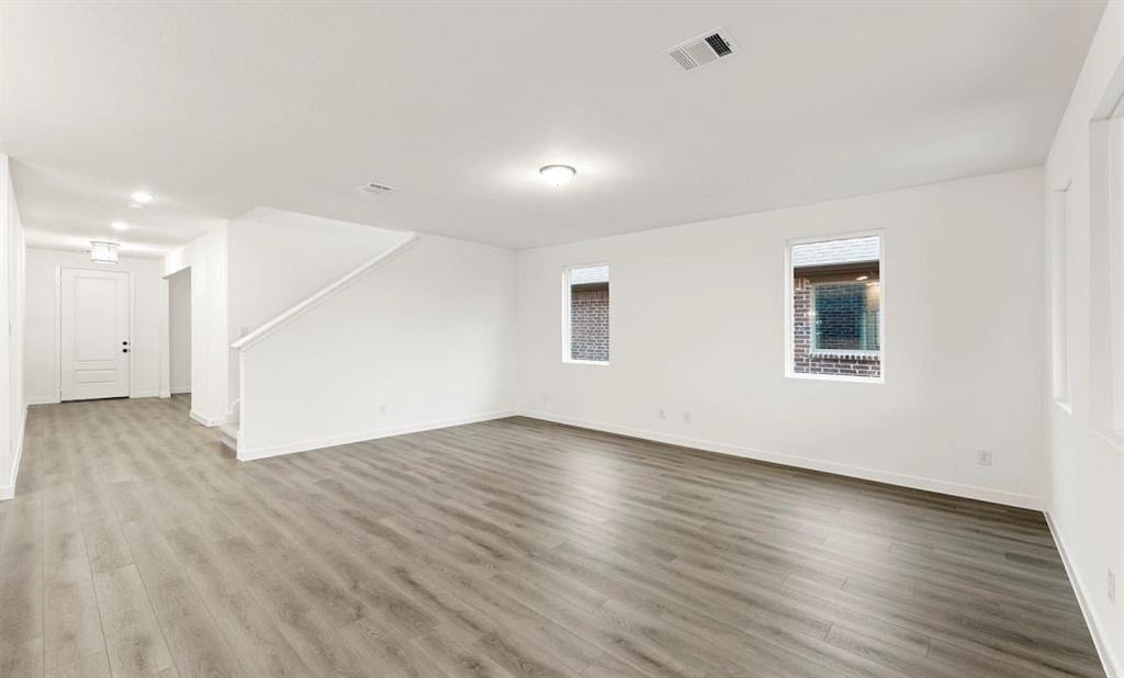 1005 Colgate Circle Princeton, TX 75407 - Photo 21 of 40 a view of an empty room with wooden floor and a window
