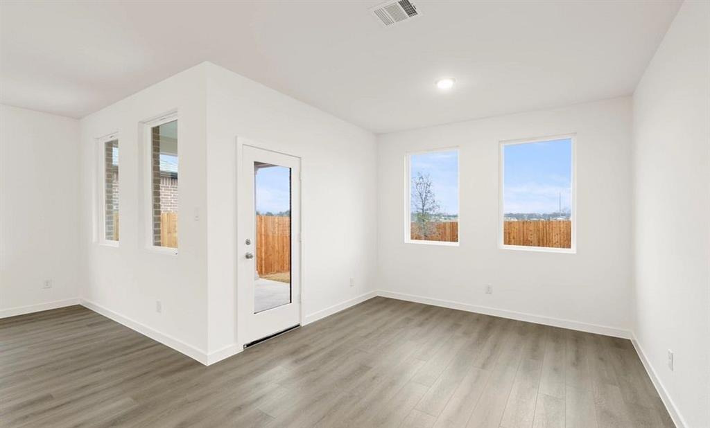 1005 Colgate Circle Princeton, TX 75407 - Photo 29 of 40 a view of an empty room with wooden floor and a window
