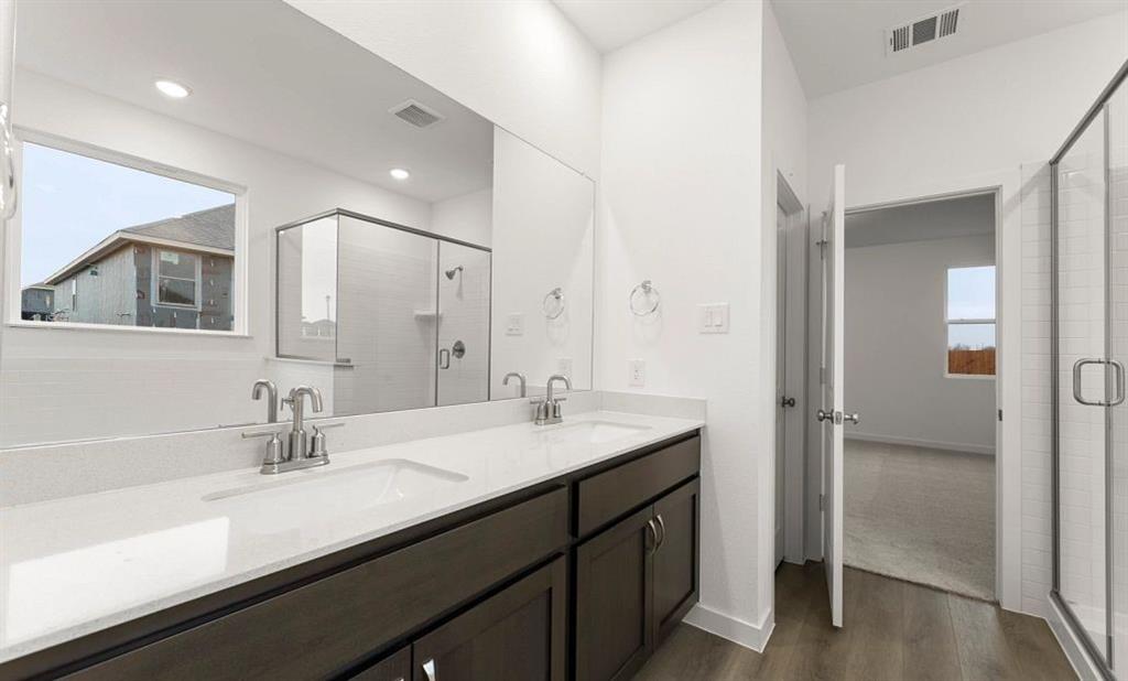 1005 Colgate Circle Princeton, TX 75407 - Photo 35 of 40 a bathroom with a sink double vanity and a mirror