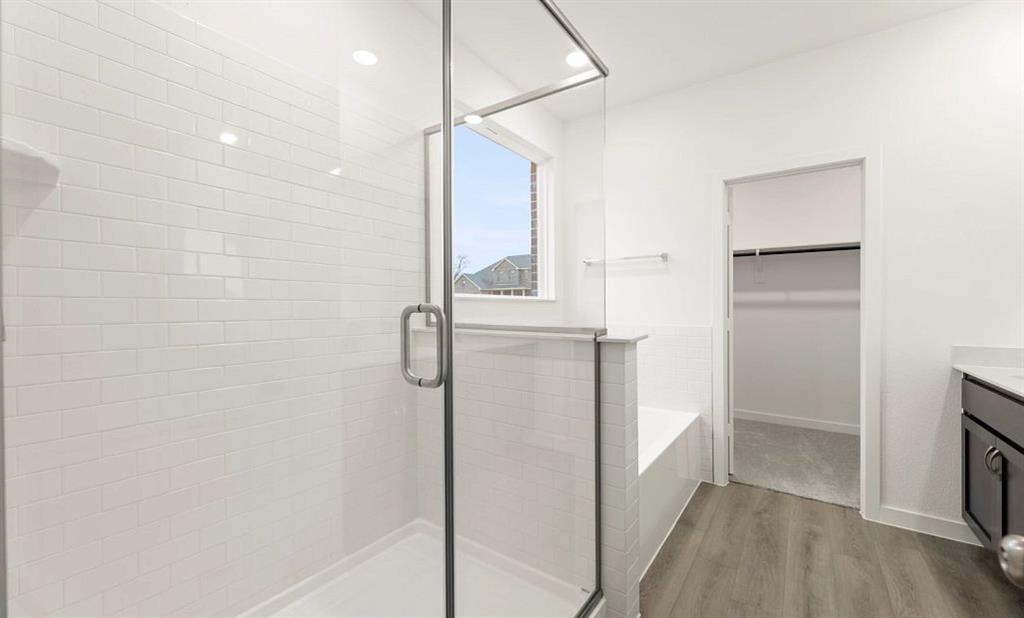 1005 Colgate Circle Princeton, TX 75407 - Photo 36 of 40 a bathroom with a shower and a mirror